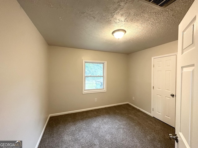 2930 Waters Rd, Atlanta, GA 30354 - unfurnished room featuring visible vents, a textured ceiling, dark carpet, and baseboards