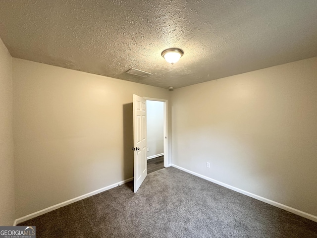 2930 Waters Rd, Atlanta, GA 30354 - spare room with a textured ceiling, visible vents, baseboards, and dark colored carpet