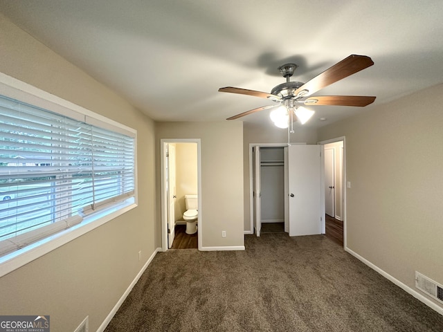 unfurnished bedroom with visible vents, baseboards, a closet, ensuite bathroom, and carpet flooring