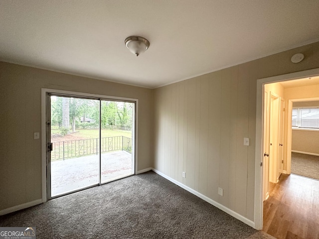 spare room featuring baseboards and carpet