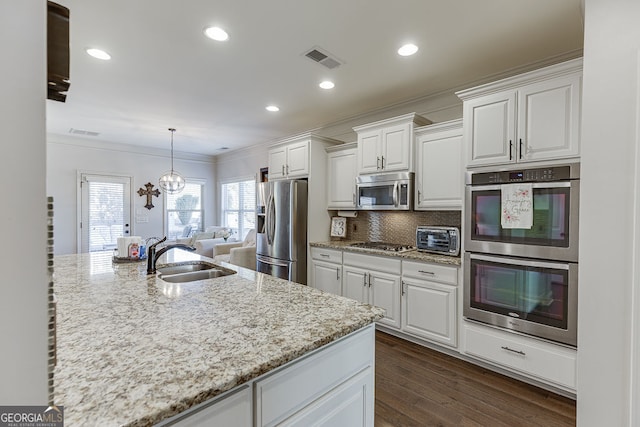 2225 Independence Ln, Buford, GA 30519 - kitchen with stainless steel appliances, crown molding, white cabinetry, light stone countertops, and tasteful backsplash
