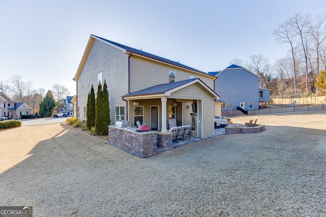 2225 Independence Ln, Buford, GA 30519 - view of front of property with a fire pit, a patio area, driveway, and stone siding