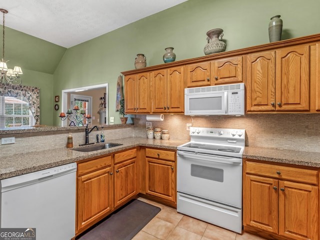 kitchen featuring tasteful backsplash, vaulted ceiling, a sink, white appliances, and light tile patterned flooring