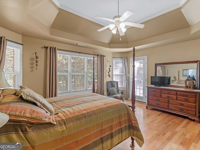 bedroom with a ceiling fan, visible vents, access to exterior, a raised ceiling, and light wood-style floors