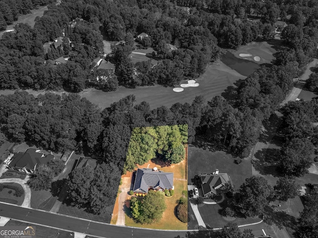 bird's eye view with a wooded view