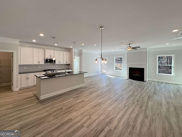 5321 Tuscany Dr, Douglasville, GA 30135 - kitchen with ornamental molding, white cabinets, dark countertops, and stainless steel appliances