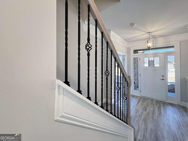 5321 Tuscany Dr, Douglasville, GA 30135 - entryway featuring ornamental molding, stairs, wood finished floors, and a notable chandelier