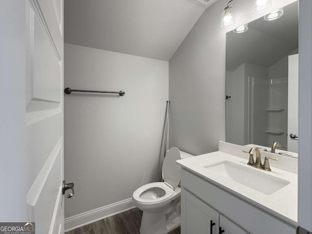 5321 Tuscany Dr, Douglasville, GA 30135 - bathroom with vanity, vaulted ceiling, toilet, and wood finished floors