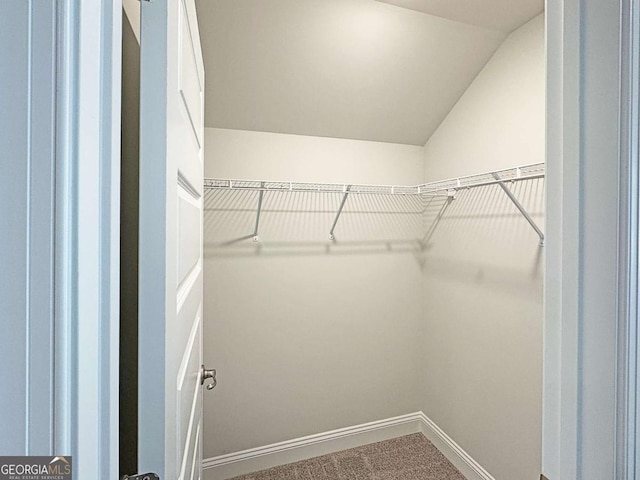 5321 Tuscany Dr, Douglasville, GA 30135 - walk in closet with carpet floors and vaulted ceiling