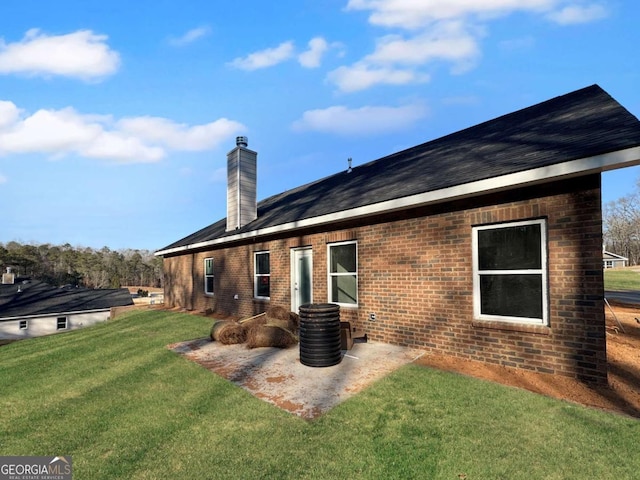 5321 Tuscany Dr, Douglasville, GA 30135 - rear view of house with a chimney, a yard, a patio area, and brick siding