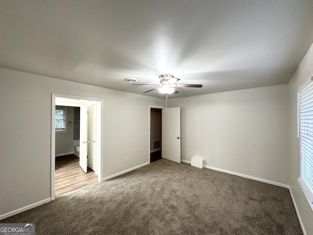 unfurnished bedroom featuring baseboards, ceiling fan, carpet, and visible vents