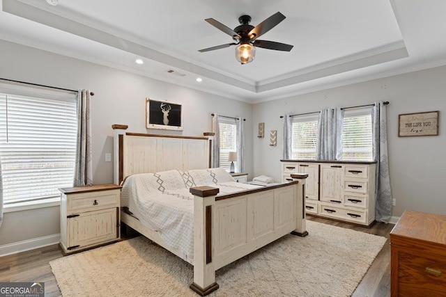 291 Higgins Rd, Flovilla, GA 30216 - bedroom with crown molding, a tray ceiling, wood finished floors, and visible vents
