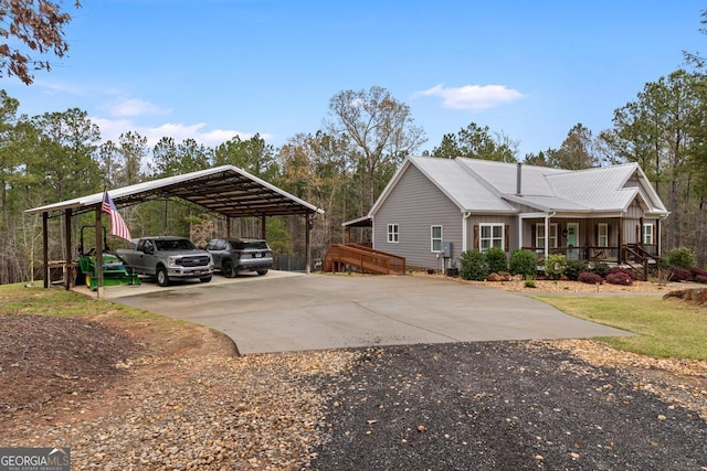 291 Higgins Rd, Flovilla, GA 30216 - view of side of home featuring a porch, a detached carport, and driveway