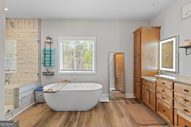 291 Higgins Rd, Flovilla, GA 30216 - full bath with vanity, baseboards, a freestanding tub, and wood finished floors