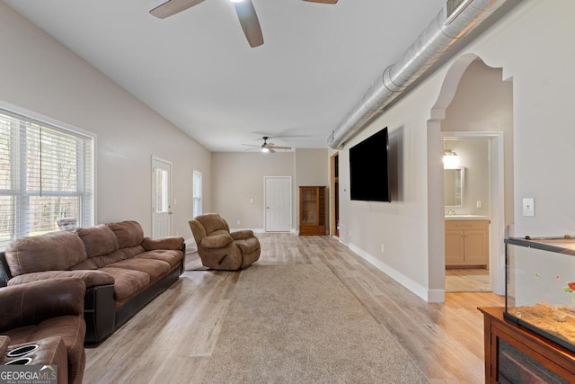 291 Higgins Rd, Flovilla, GA 30216 - living room featuring a ceiling fan, baseboards, arched walkways, and light wood-type flooring