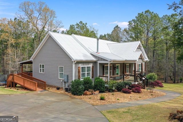 291 Higgins Rd, Flovilla, GA 30216 - view of property exterior with a trampoline, stairs, a porch, a yard, and metal roof