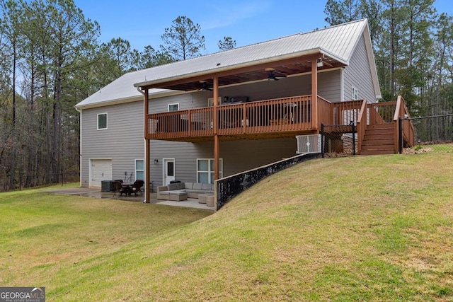 291 Higgins Rd, Flovilla, GA 30216 - back of property with a garage, a wooden deck, ceiling fan, an outdoor living space, and a lawn