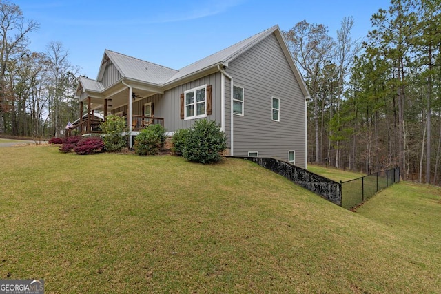 291 Higgins Rd, Flovilla, GA 30216 - view of property exterior featuring a ceiling fan, board and batten siding, fence, and a yard