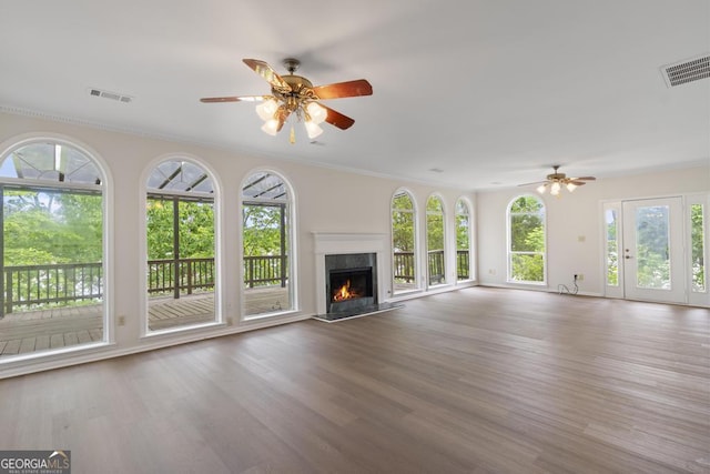 unfurnished living room featuring ceiling fan, a premium fireplace, and visible vents