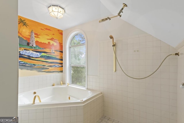bathroom with a tub with jets and a tile shower