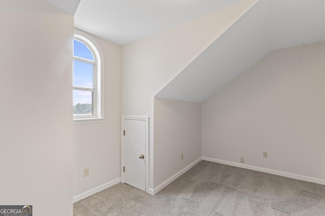 bonus room with carpet floors, baseboards, and lofted ceiling