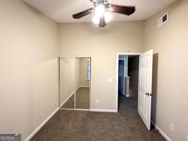 263 Coral Cir, Mcdonough, GA 30253 - unfurnished bedroom featuring a ceiling fan, visible vents, baseboards, a closet, and dark carpet