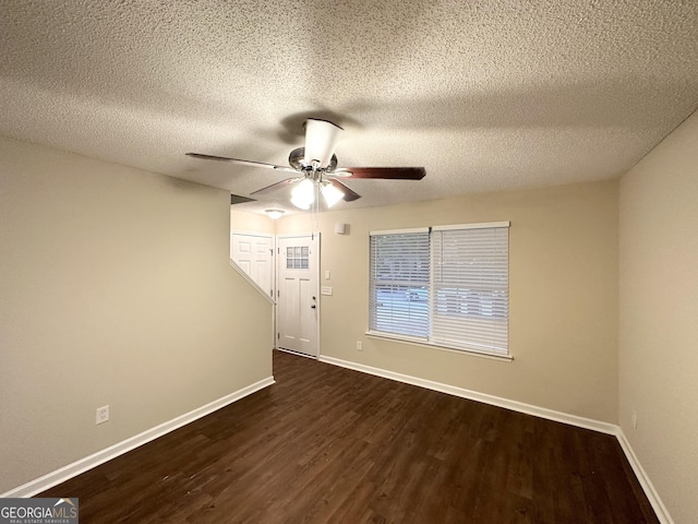 263 Coral Cir, Mcdonough, GA 30253 - unfurnished room featuring baseboards, ceiling fan, dark wood-style flooring, and a textured ceiling