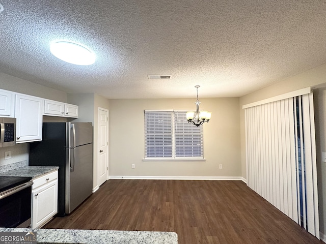 263 Coral Cir, Mcdonough, GA 30253 - kitchen with visible vents, appliances with stainless steel finishes, an inviting chandelier, white cabinetry, and dark wood-type flooring