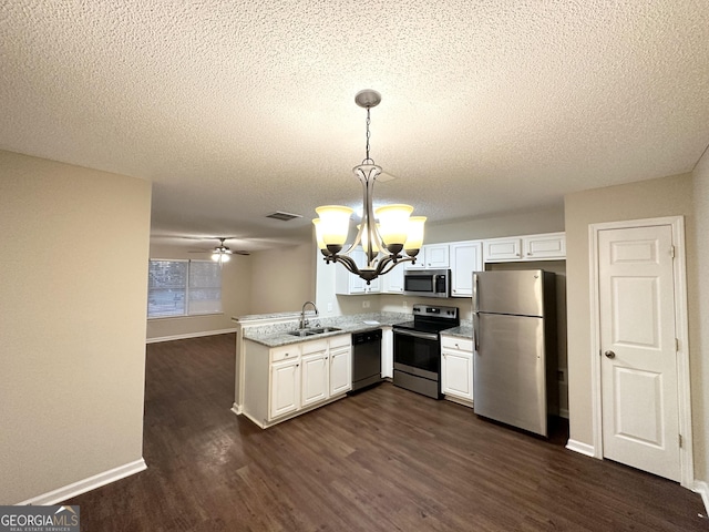 263 Coral Cir, Mcdonough, GA 30253 - kitchen featuring dark wood-style flooring, a textured ceiling, visible vents, appliances with stainless steel finishes, and a sink
