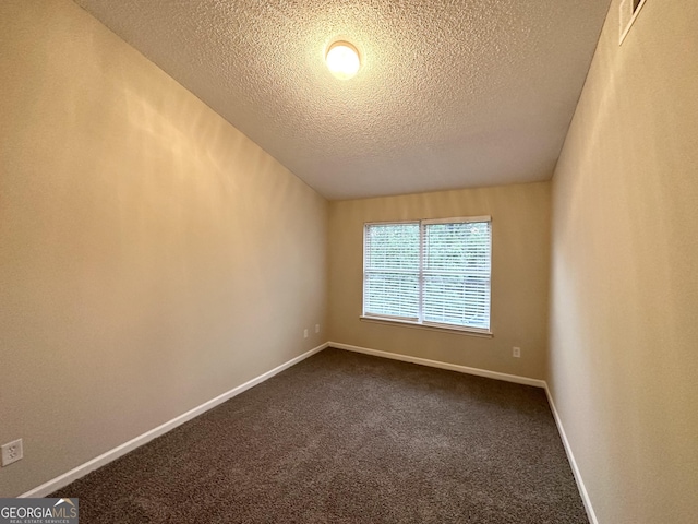 263 Coral Cir, Mcdonough, GA 30253 - unfurnished room featuring a textured ceiling, baseboards, and dark colored carpet