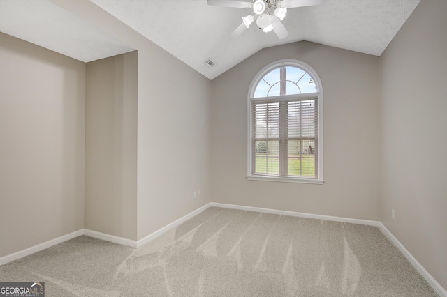 empty room with baseboards, carpet, ceiling fan, and vaulted ceiling