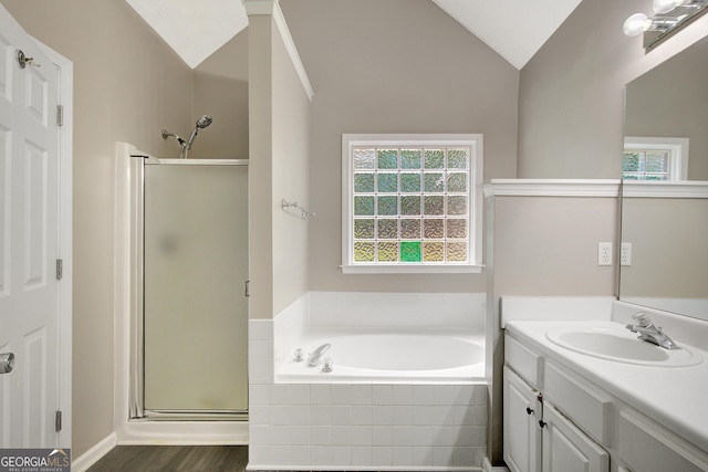 bathroom featuring vanity, a garden tub, vaulted ceiling, and a shower stall