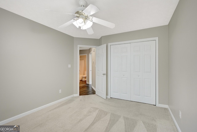 unfurnished bedroom with a closet, baseboards, and carpet flooring