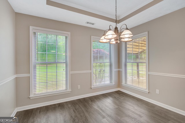 unfurnished dining area with crown molding, dark wood-style flooring, a chandelier, baseboards, and visible vents