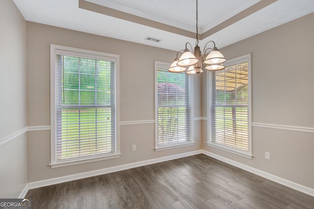 35 Wenham Ln, Sharpsburg, GA 30277 - unfurnished dining area with crown molding, dark wood-style flooring, a chandelier, baseboards, and visible vents