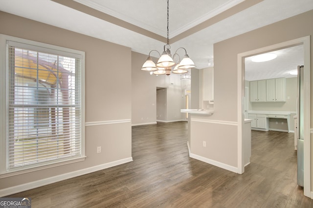 unfurnished dining area with crown molding, baseboards, a chandelier, and dark wood-type flooring