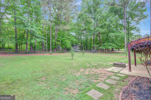 view of yard with a fenced backyard, an outdoor fire pit, and a patio area