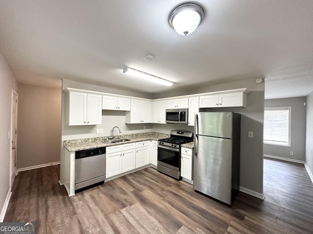 830 Mercury Dr, Atlanta, GA 30331 - kitchen with a sink, dark wood finished floors, light stone countertops, and stainless steel appliances