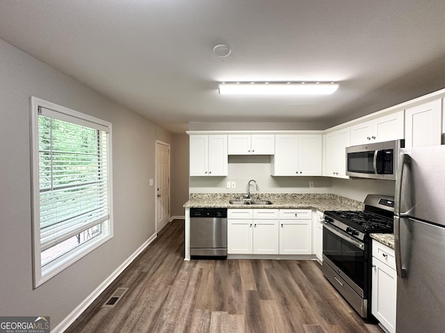 830 Mercury Dr, Atlanta, GA 30331 - kitchen featuring a sink, dark wood finished floors, appliances with stainless steel finishes, and white cabinetry