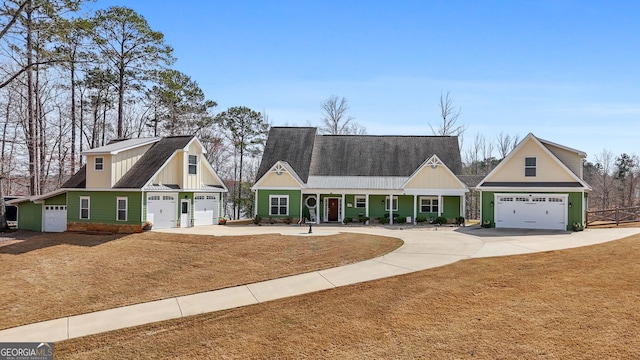 view of front of home with driveway, an attached garage, board and batten siding, and roof with shingles