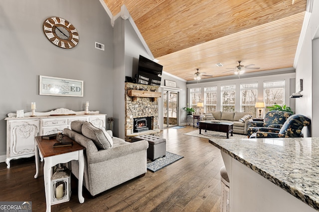 living room with wooden ceiling, crown molding, a ceiling fan, dark wood-style floors, and a fireplace