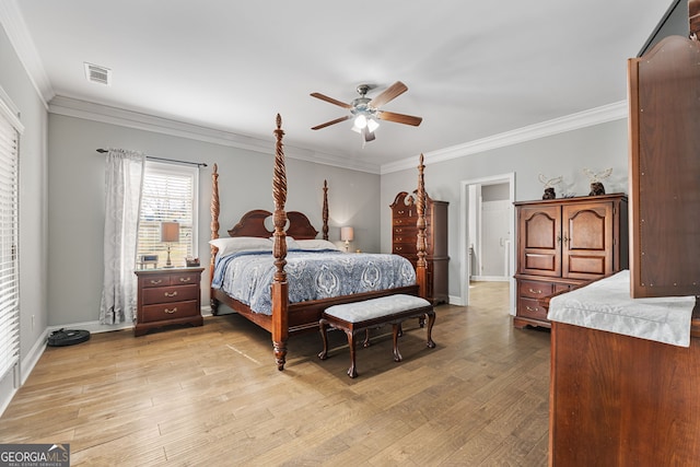 bedroom featuring crown molding, light wood-style flooring, baseboards, and ceiling fan