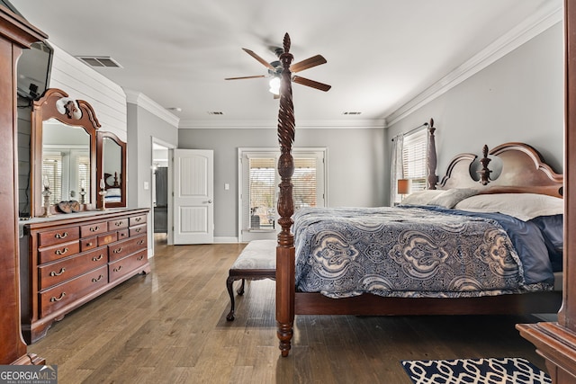 bedroom with wood finished floors, ornamental molding, baseboards, and a ceiling fan