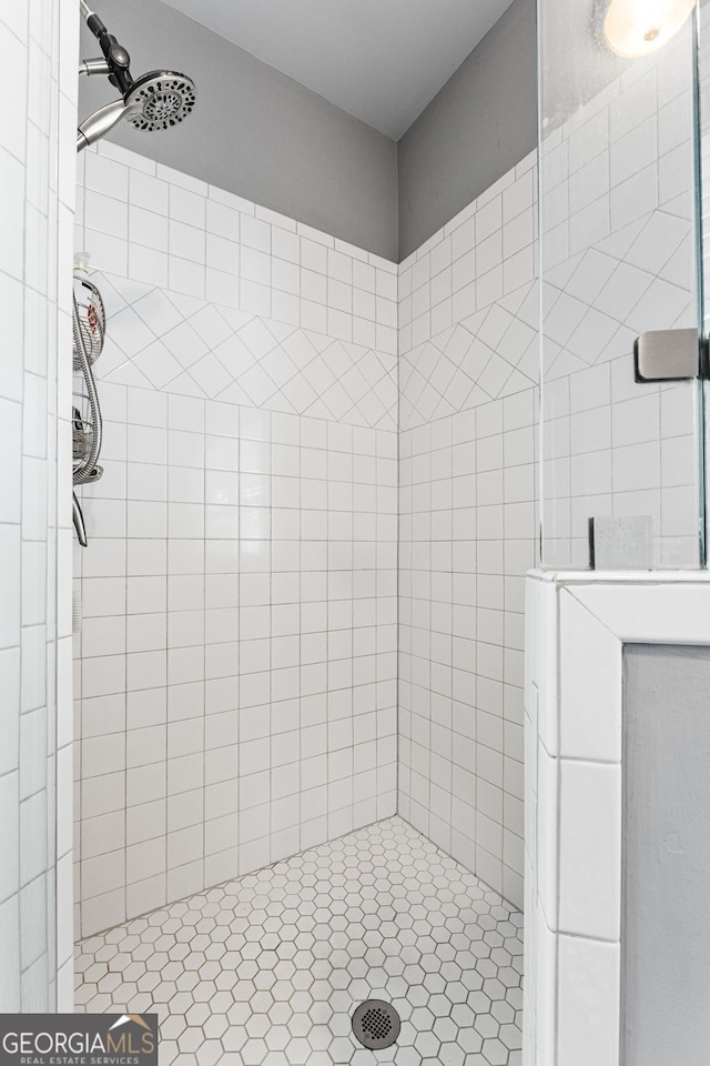 full bath with a tile shower