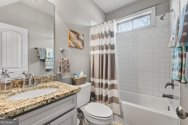 bathroom featuring toilet, shower / tub combo with curtain, and vanity