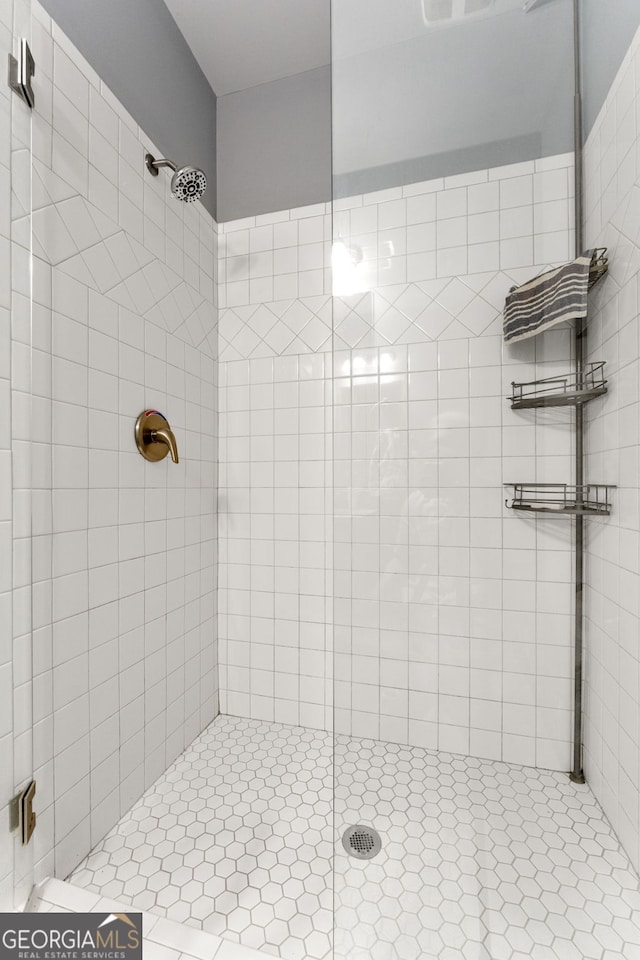 bathroom with tiled shower