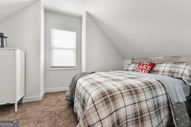 bedroom featuring carpet floors, lofted ceiling, and baseboards