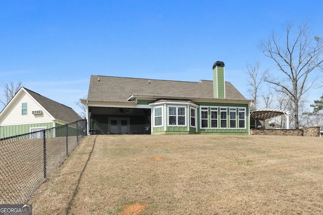 back of house featuring a shingled roof, a chimney, ceiling fan, a carport, and a pergola