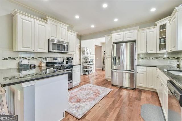 37 Wood Duck Pt, Jefferson, GA 30549 - kitchen featuring appliances with stainless steel finishes, decorative backsplash, a peninsula, ornamental molding, and white cabinetry