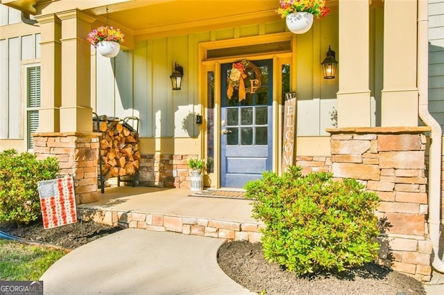 37 Wood Duck Pt, Jefferson, GA 30549 - view of exterior entry featuring board and batten siding, covered porch, and stone siding
